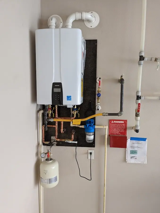 Professional plumber installing copper piping in a Polk City home